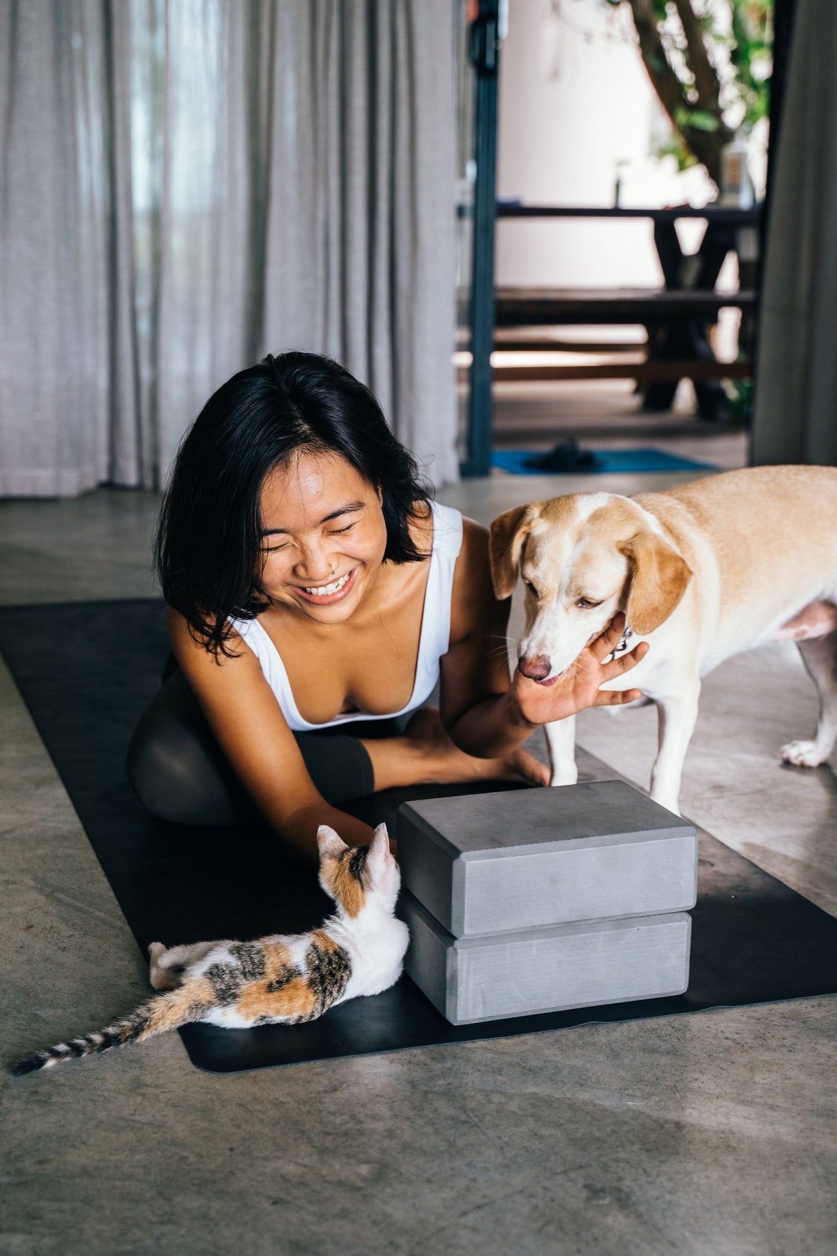 Woman relaxing at home with her dog and cat
